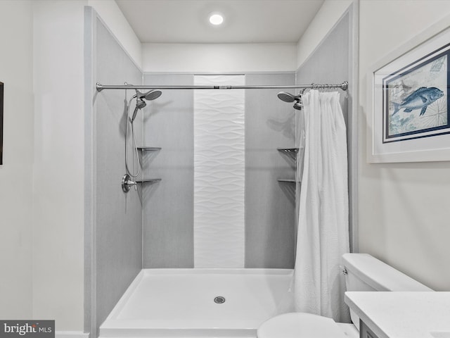 bathroom with vanity, toilet, and walk in shower