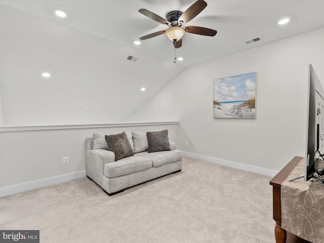 sitting room featuring ceiling fan, light carpet, and lofted ceiling