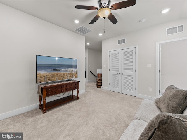 living area featuring ceiling fan and light colored carpet