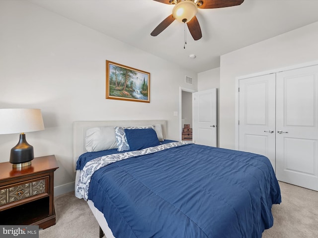 bedroom featuring light carpet, a closet, and ceiling fan