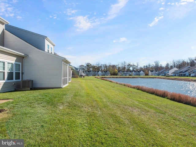 view of yard featuring a water view and central air condition unit