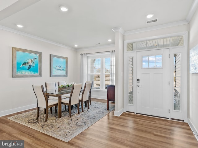 entryway featuring wood-type flooring and ornamental molding