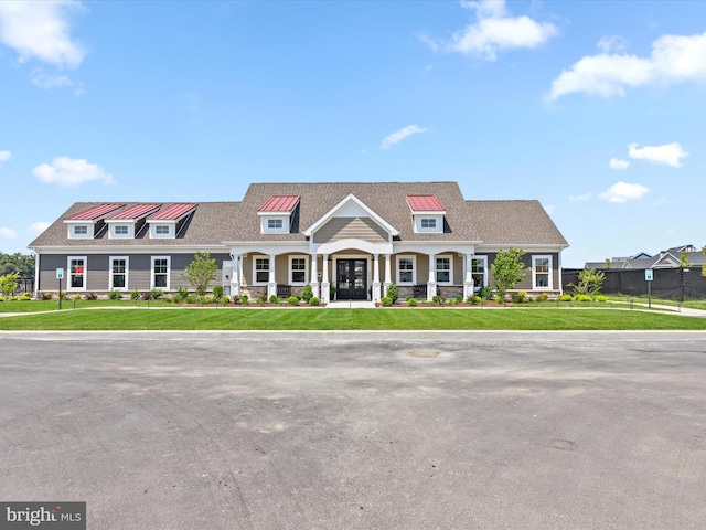 view of front facade featuring covered porch and a front lawn