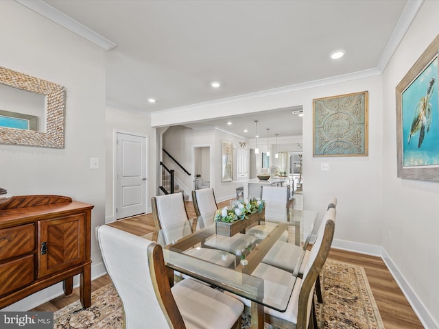 dining area featuring light hardwood / wood-style flooring and ornamental molding