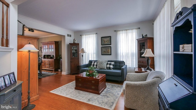 living room featuring ornamental molding and hardwood / wood-style flooring