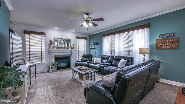 living room with ceiling fan, carpet floors, and crown molding