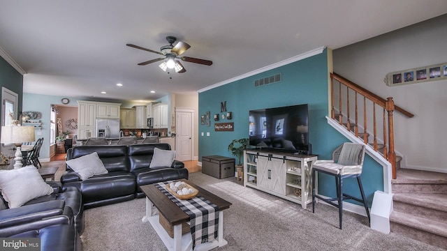 carpeted living room featuring ceiling fan and ornamental molding