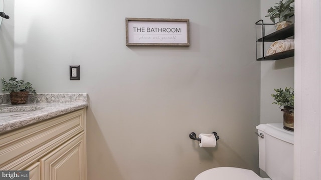 bathroom featuring toilet and vanity