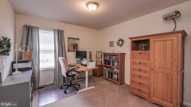 office area featuring light carpet