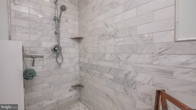 bathroom with a tile shower