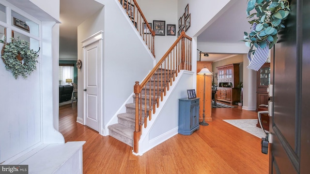 foyer featuring hardwood / wood-style flooring and crown molding