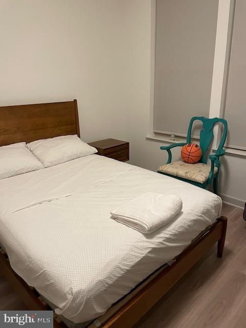 bedroom with wood-type flooring