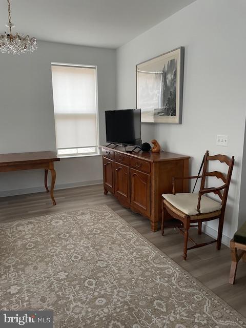 interior space with light wood-type flooring and a notable chandelier