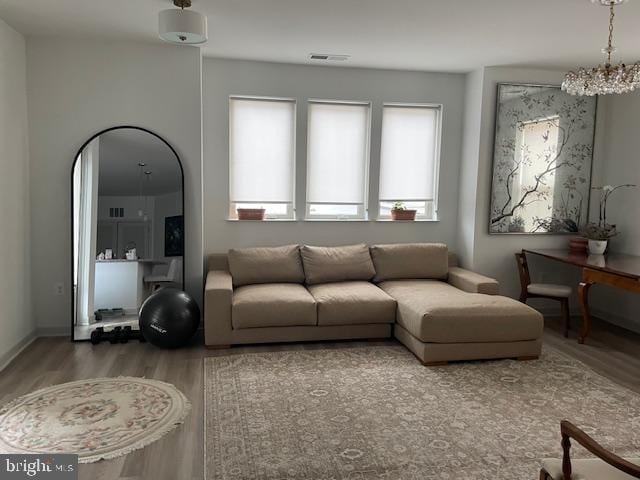 living room with a chandelier and hardwood / wood-style flooring