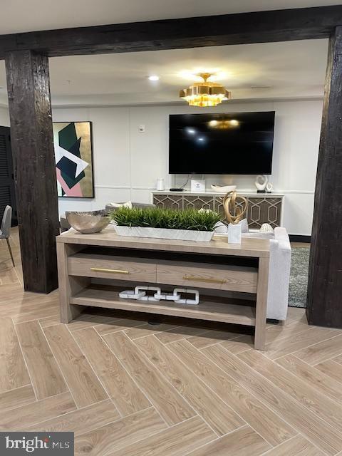 living room featuring parquet floors and beamed ceiling