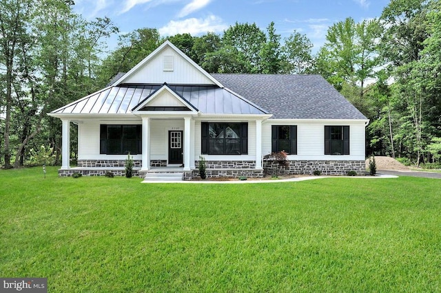 modern farmhouse featuring a front yard and a porch