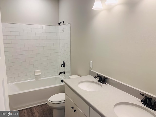 full bathroom featuring hardwood / wood-style flooring, toilet, vanity, and shower / bathtub combination