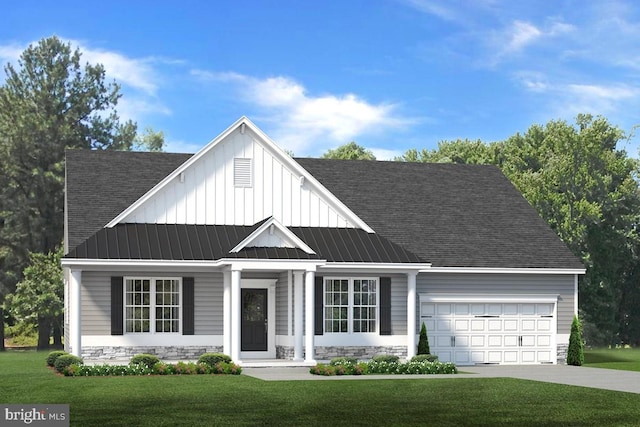 view of front of home with a front yard and a garage