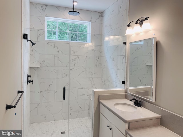 bathroom featuring vanity and a shower with door