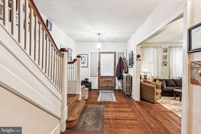 foyer featuring radiator and dark wood-type flooring