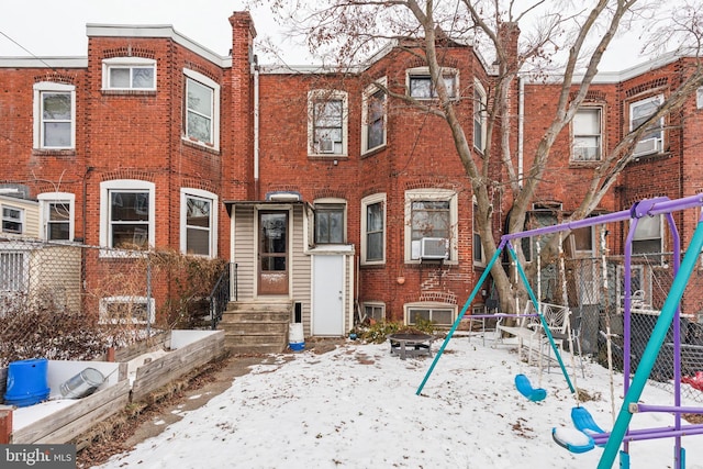 view of property with cooling unit and a playground