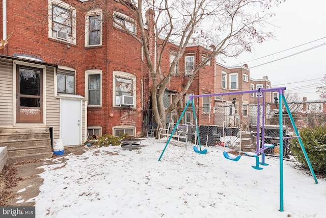 snow covered playground featuring cooling unit