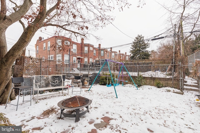 snow covered playground featuring a fire pit