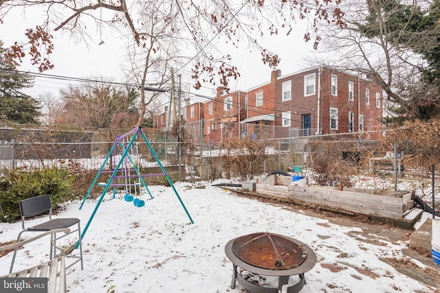 snow covered playground with a fire pit