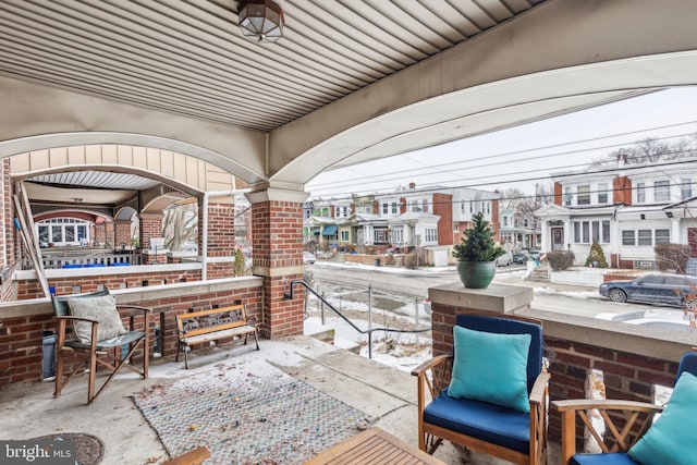 snow covered patio with a bar