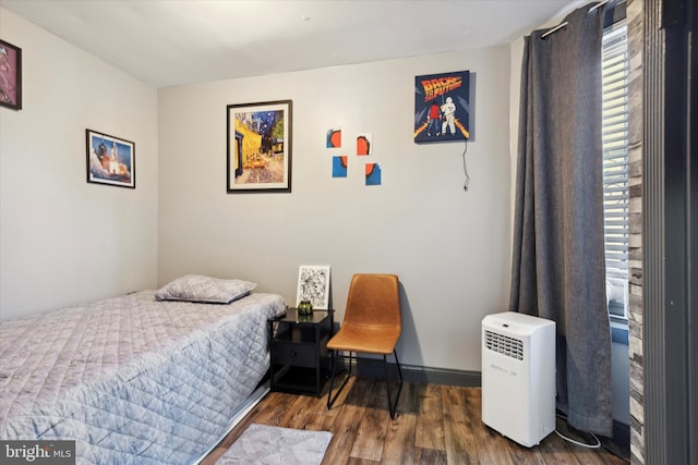 bedroom with dark wood-type flooring