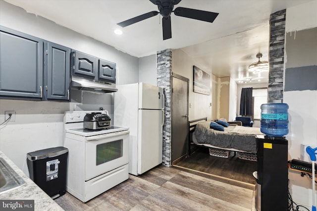 kitchen with hardwood / wood-style flooring, sink, white appliances, and ceiling fan