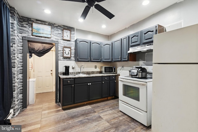 kitchen featuring ceiling fan, sink, white appliances, and hardwood / wood-style floors