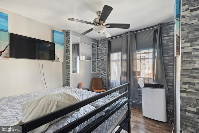 bedroom featuring ceiling fan and dark hardwood / wood-style floors