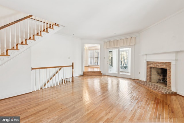 unfurnished living room with ornamental molding, a fireplace, and hardwood / wood-style floors