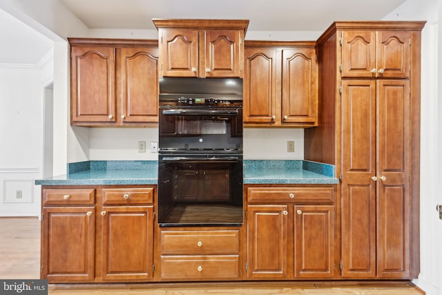 kitchen featuring crown molding and double oven