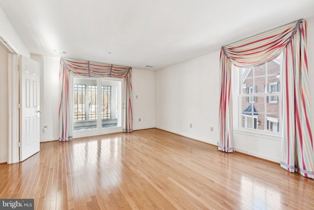 spare room with hardwood / wood-style floors