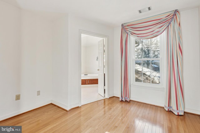 spare room featuring light hardwood / wood-style flooring