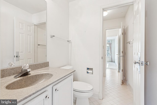 bathroom with toilet, tile patterned flooring, and vanity