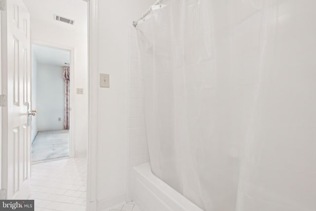 bathroom featuring tile patterned flooring and shower / bath combination with curtain