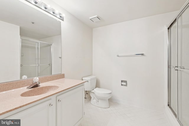 bathroom with vanity, toilet, walk in shower, and tile patterned floors