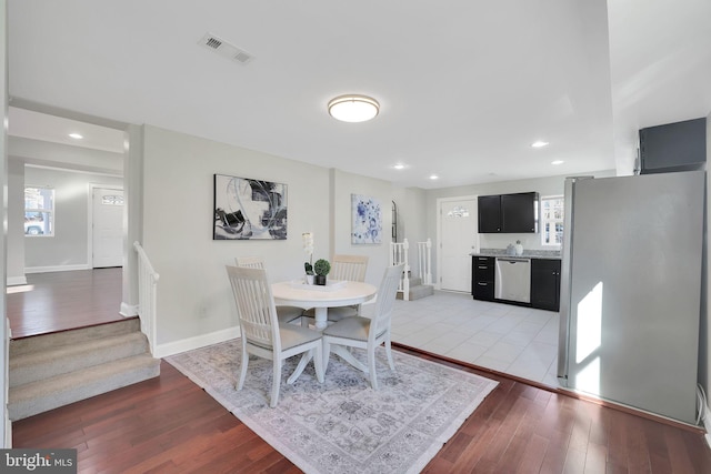 dining room with visible vents, baseboards, stairs, recessed lighting, and wood-type flooring