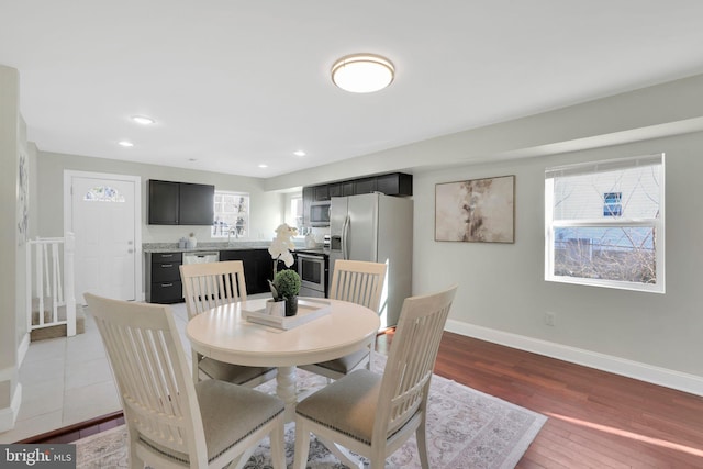 dining room featuring recessed lighting, baseboards, and dark wood finished floors