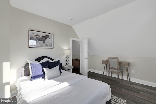 bedroom featuring lofted ceiling, baseboards, and dark wood-style flooring