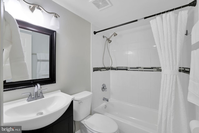 full bath with vanity, shower / tub combo, toilet, and visible vents