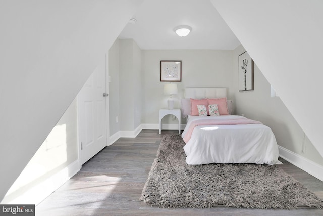 bedroom with wood finished floors and baseboards