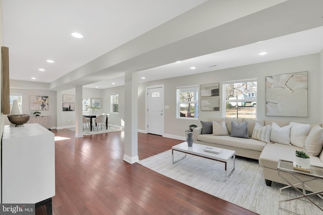 living room with recessed lighting, baseboards, and dark wood-type flooring