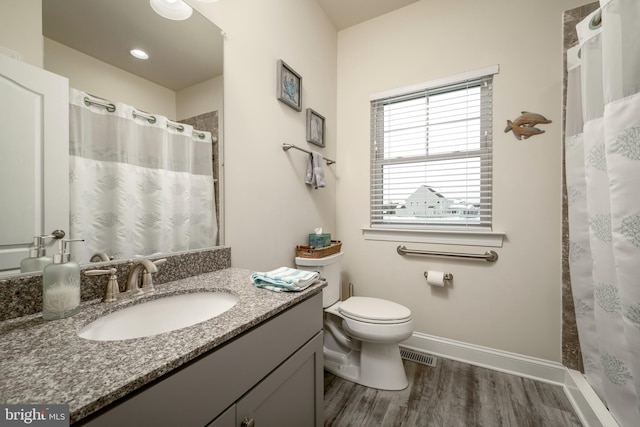 bathroom with toilet, vanity, a shower with shower curtain, and hardwood / wood-style flooring