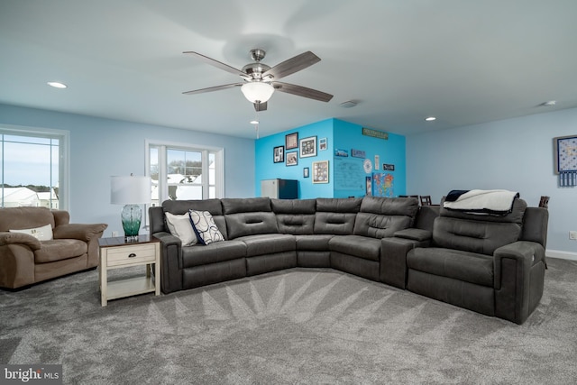 carpeted living room featuring ceiling fan and a healthy amount of sunlight