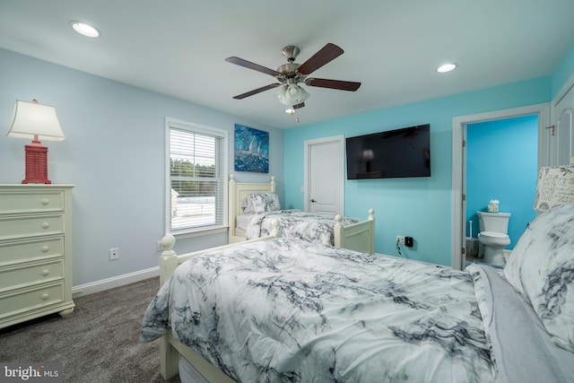 bedroom featuring ceiling fan, ensuite bathroom, and dark carpet