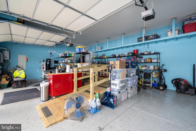 garage featuring water heater and a garage door opener